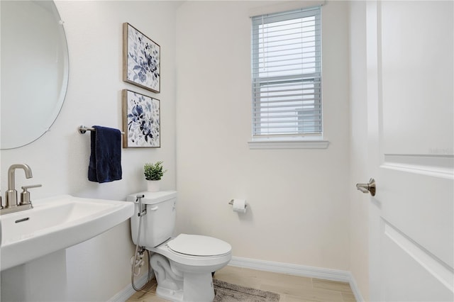 bathroom with hardwood / wood-style floors, toilet, and sink