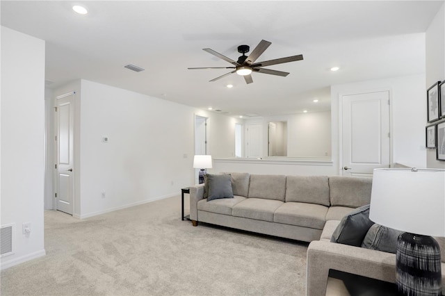 living room with ceiling fan and light colored carpet