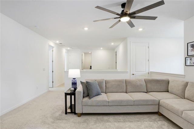 carpeted living room with ceiling fan