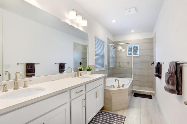 bathroom with separate shower and tub and vanity