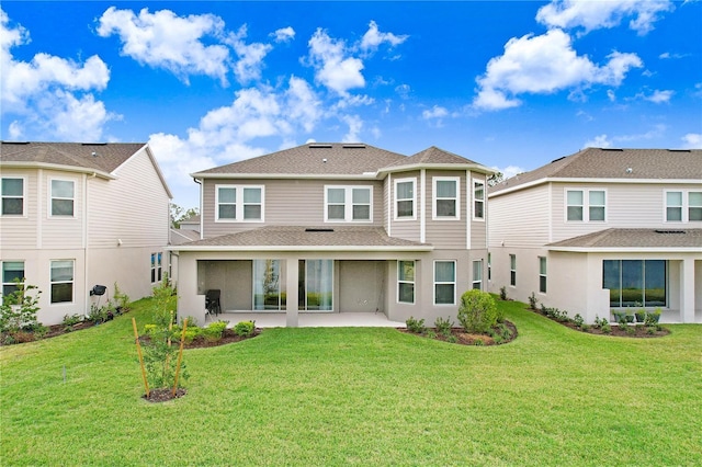 back of house featuring a patio area and a yard