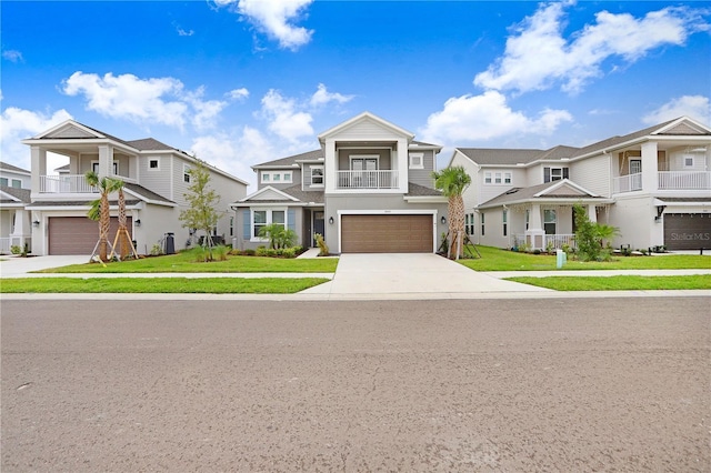 multi unit property with a garage, a balcony, and a front yard