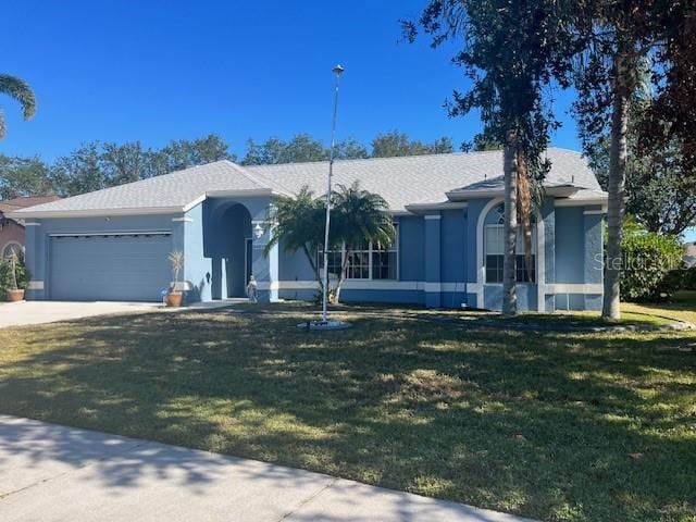 single story home with a front yard and a garage