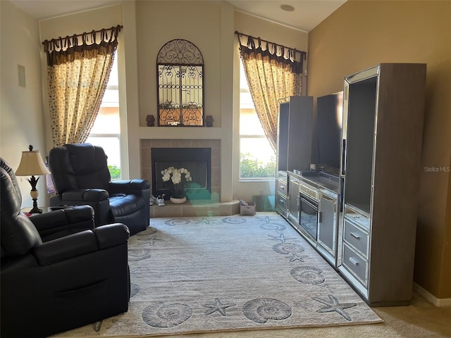 living room featuring carpet, a fireplace, and a wealth of natural light