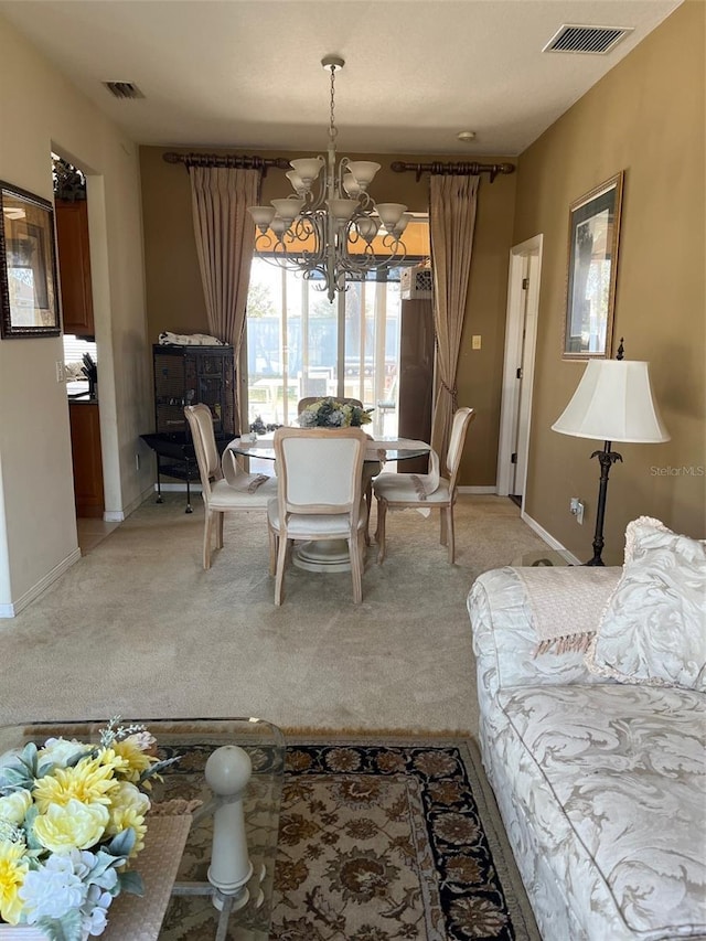 carpeted dining space with a chandelier