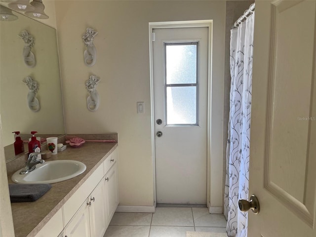 bathroom with tile patterned flooring, vanity, and curtained shower