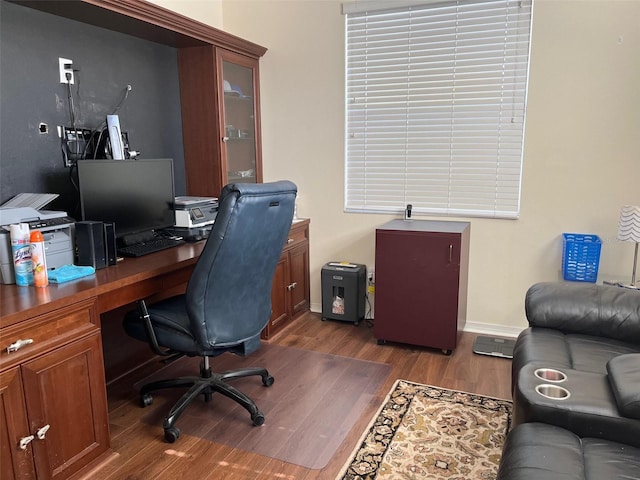 home office with dark hardwood / wood-style flooring