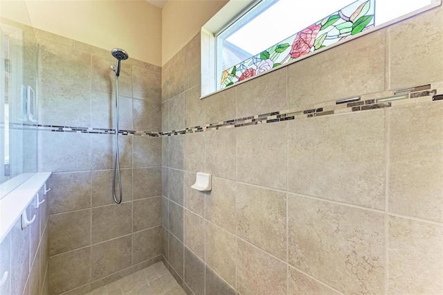 bathroom with tiled shower