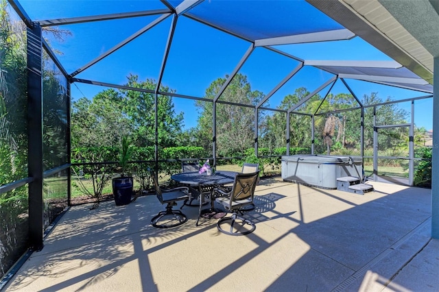 view of patio / terrace with a lanai and a hot tub