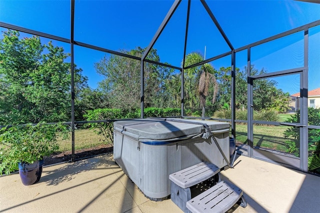 view of patio with a lanai and a hot tub