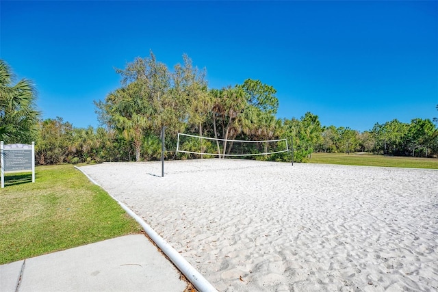 surrounding community with a lawn and volleyball court