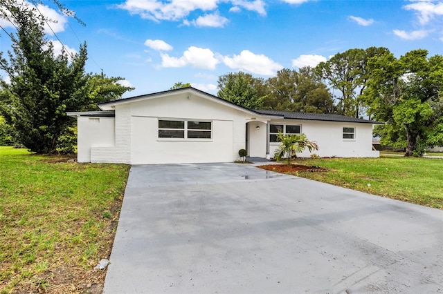 ranch-style home with a front lawn