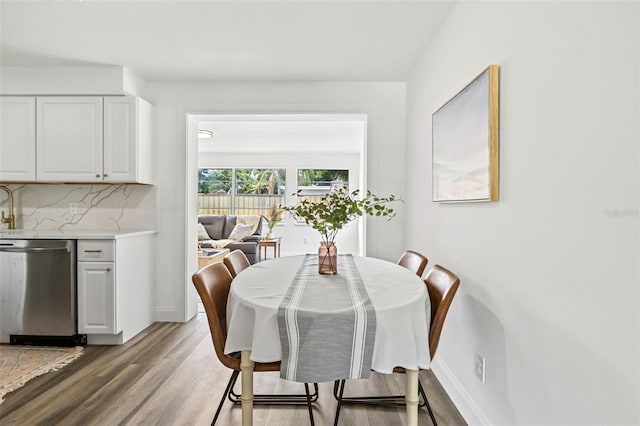 dining space with hardwood / wood-style flooring