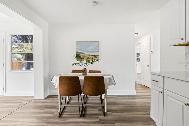 dining space with light wood-type flooring