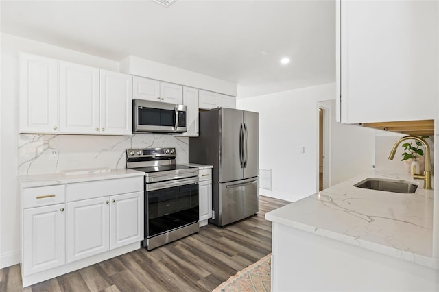 kitchen featuring dark hardwood / wood-style floors, white cabinetry, sink, and appliances with stainless steel finishes