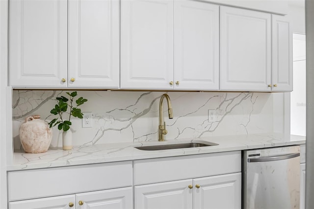 kitchen featuring white cabinetry, sink, tasteful backsplash, light stone counters, and stainless steel dishwasher