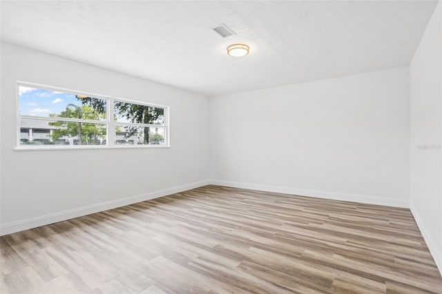 spare room with light hardwood / wood-style flooring