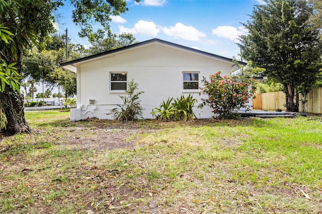 view of side of property with a yard