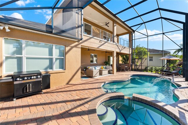 view of pool featuring outdoor lounge area, a grill, ceiling fan, glass enclosure, and a patio area