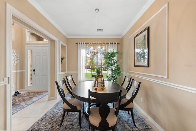 tiled dining area featuring an inviting chandelier and ornamental molding