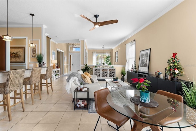 dining room with ornamental molding, light tile patterned flooring, and ceiling fan