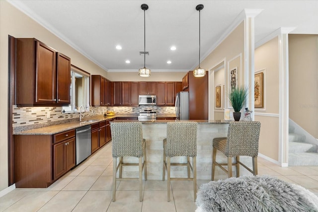 kitchen featuring sink, crown molding, stainless steel appliances, light stone counters, and a kitchen island