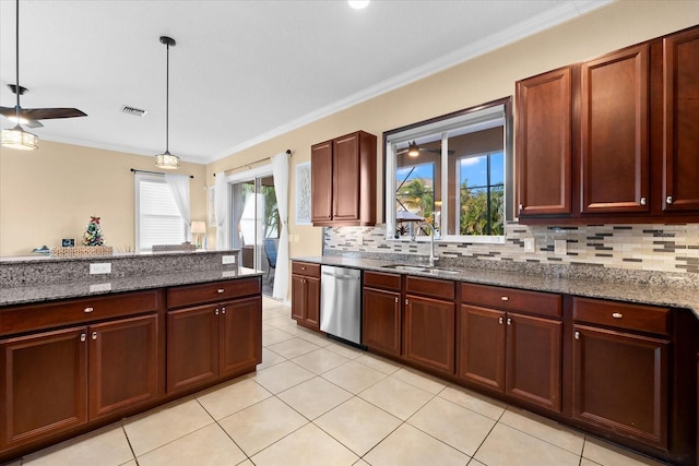 kitchen featuring pendant lighting, sink, dark stone counters, ornamental molding, and stainless steel dishwasher