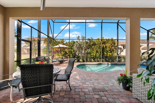 view of swimming pool with a patio and glass enclosure