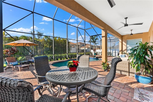 view of patio / terrace featuring a lanai and ceiling fan