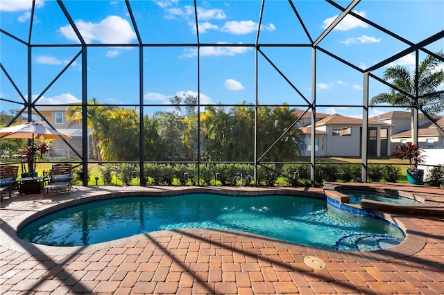 view of swimming pool with an in ground hot tub, a lanai, and a patio