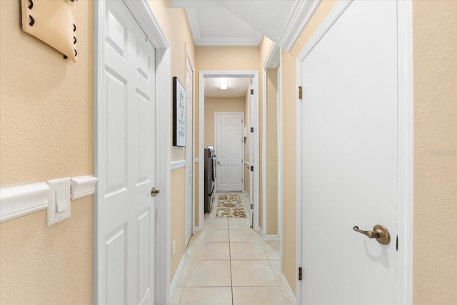 hallway with crown molding and light tile patterned floors