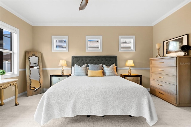 carpeted bedroom featuring multiple windows, crown molding, and ceiling fan