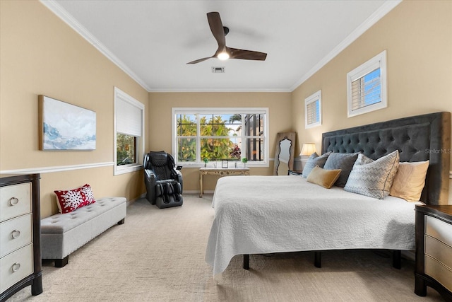 carpeted bedroom with ornamental molding and ceiling fan