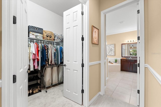 spacious closet featuring light tile patterned flooring