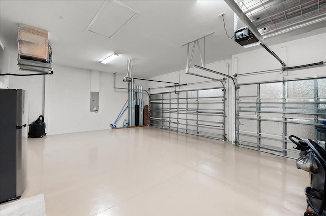 garage featuring stainless steel refrigerator, a garage door opener, and electric panel