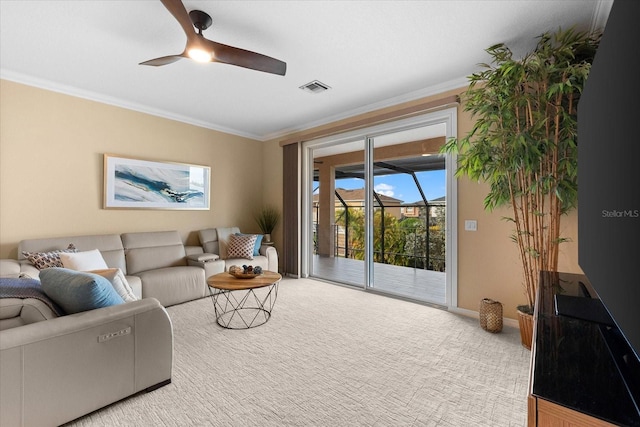 living room featuring light carpet, ornamental molding, and ceiling fan