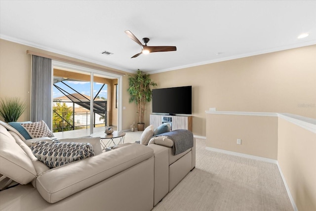 living room featuring crown molding, light colored carpet, and ceiling fan