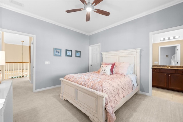 carpeted bedroom with crown molding, ceiling fan, ensuite bathroom, and sink