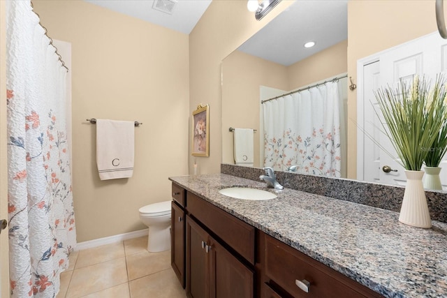 bathroom with vanity, tile patterned floors, and toilet