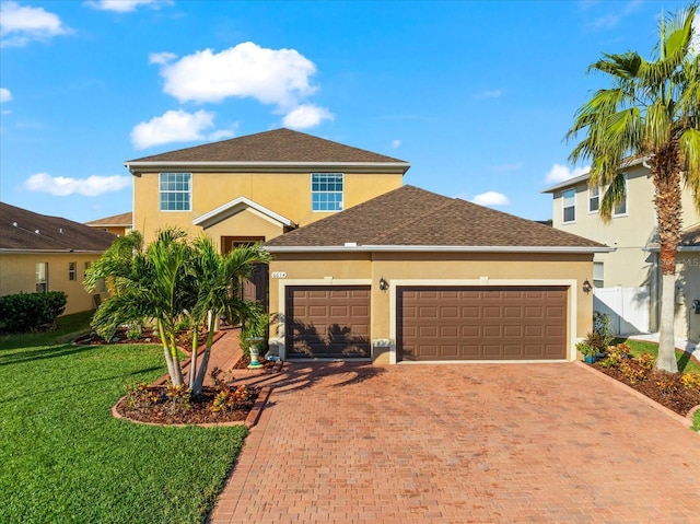 view of front facade with a garage and a front lawn