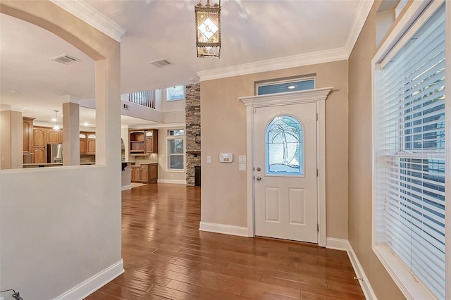 entrance foyer featuring crown molding and dark hardwood / wood-style flooring