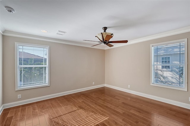 spare room featuring crown molding, ceiling fan, and wood-type flooring