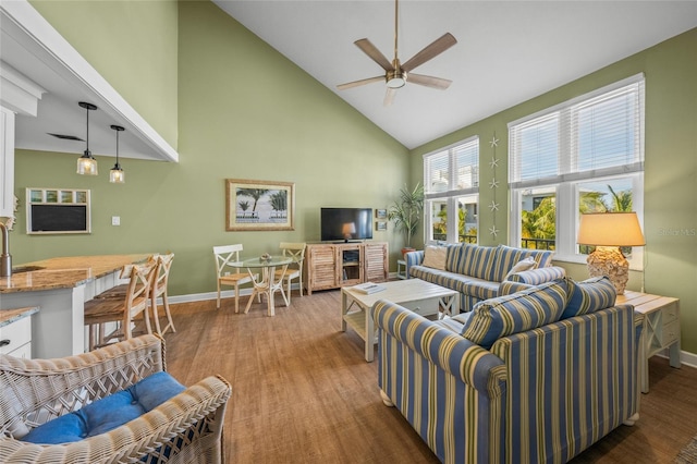 living room with ceiling fan, sink, dark wood-type flooring, and high vaulted ceiling