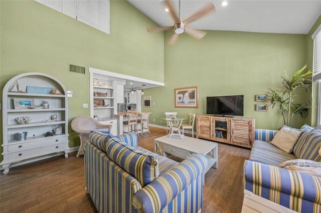 living room with high vaulted ceiling, ceiling fan, and dark wood-type flooring