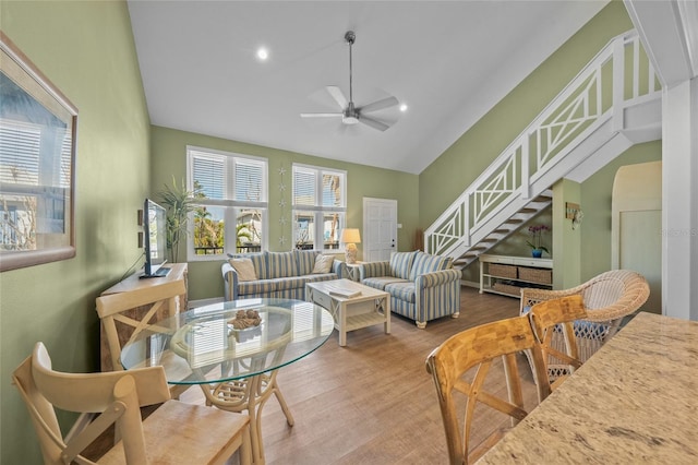 living room featuring ceiling fan, hardwood / wood-style floors, and high vaulted ceiling