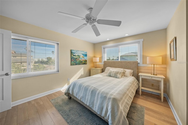 bedroom with ceiling fan and light hardwood / wood-style flooring