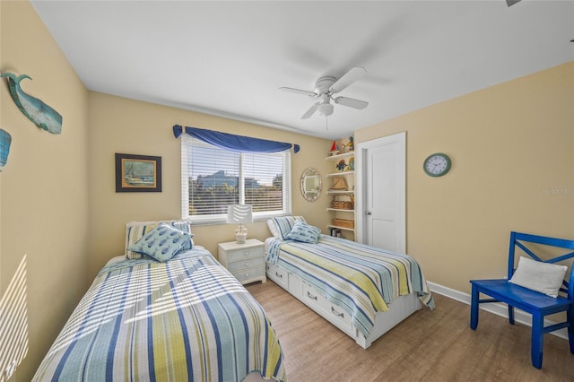 bedroom with ceiling fan and light hardwood / wood-style floors