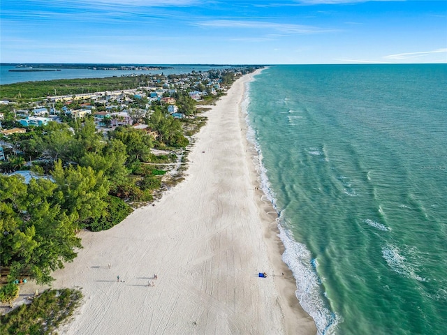 birds eye view of property with a water view and a view of the beach