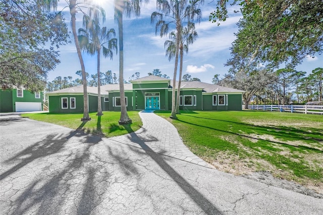 ranch-style home with a front lawn