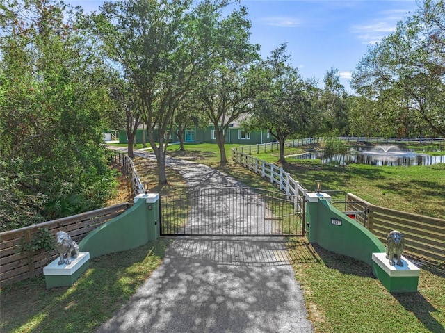 view of community featuring a yard and a water view